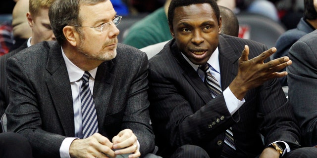 FILE- In this Dec. 17, 2011, file photo, New Jersey Nets head coach Avery Johnson, right, talks with assistant coach P.J. Carlesimo during the first half of an NBA preseason basketball game against the New York Knicks in Newark, N.J. The Nets fired Johnson on Thursday, Dec. 27, 2012, and Carlesimo will coach the team on an interim basis, starting Friday night with a home game against Charlotte. (AP Photo/Mel Evans, File)