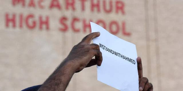 A sign supporting Ahmed Mohamed is held up in front of MacArthur High School at a prayer vigil, Thursday, Sept. 17, 2015, in Irving, Texas. Ahmed, 14, was arrested Monday when a clock he built and brought to school was mistaken for a bomb by teachers and police. (AP Photo/Jeffrey McWhorter).