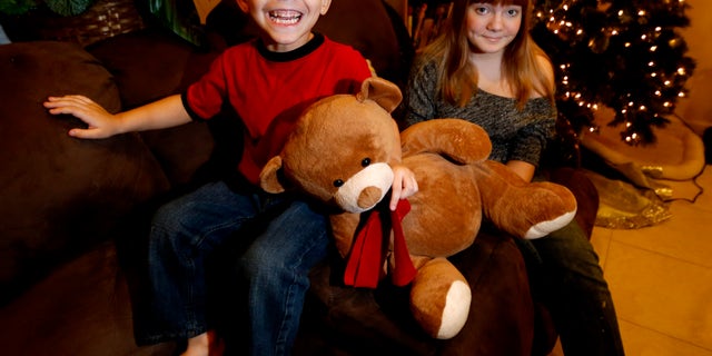 Dec. 6, 2012: McKenna Pope, 13, right, and her brother Gavyn Boscio, 4, pose for a photo at their home in Garfield, N.J.