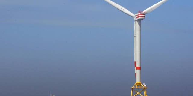 FILE - In this April 26, 2010 file photo a boat approaches a German windmill offshore power plant in the North Sea, 45 km off the coast of Norddeich. (AP Photo/Frank Augstein, file)
