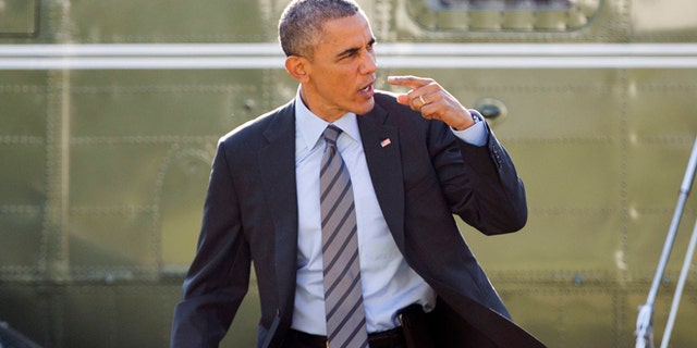 President Barack Obama signals to his aides and staff that he will return to the White House because he forgot something before his departure on Marine One helicopter, Friday, Nov., 21, 2014, in Washington. Obama is traveling to Las Vegas to promote an executive order that would offer temporary legal status to millions of immigrants who are in the country illegally and set off a new fight with Republicans in Congress. (AP Photo/Pablo Martinez Monsivais)