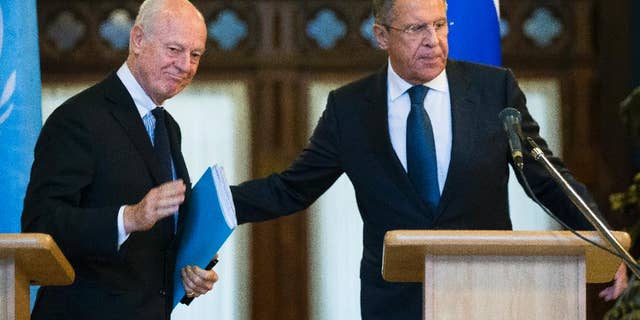 Russian Foreign Minister Sergey Lavrov, right, and U.N. Special Envoy for Syria Staffan de Mistura leave a news conference following their talks in Moscow, Russia, Wednesday, Nov. 4, 2015. Lavrov says he hopes that international peacebrokers in the coming days will agree on the list of opposition groups that should be invited to peace talks. (AP Photo/Alexander Zemlianichenko)