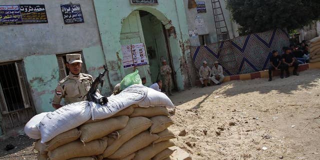 May 26, 2014: An Egyptian soldier stands guard at a polling center of a presidential election that comes nearly a year after the military's ouster of the nation's first freely elected president, the Islamist Mohammed Morsi, in his homeland al-Adwa village near Zagazig, 63 miles northeast of Cairo, Egypt.