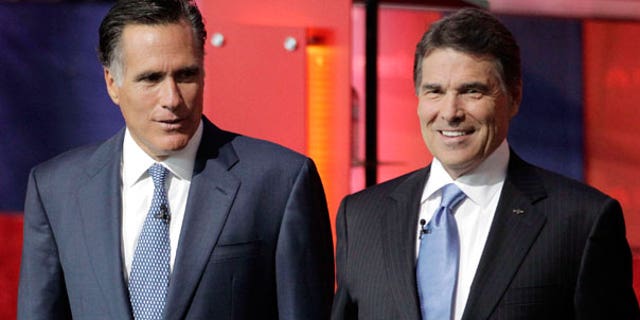 Spet. 7: Republican presidential candidates former Massachusetts Gov. Mitt Romney, left, and Texas Gov. Rick Perry, stand together before a Republican presidential candidate debate at the Reagan Library in Simi Valley, Calif.