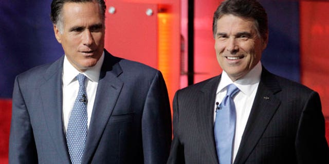 Spet. 7: Republican presidential candidates former Massachusetts Gov. Mitt Romney, left, and Texas Gov. Rick Perry, stand together before a Republican presidential candidate debate at the Reagan Library in Simi Valley, Calif.