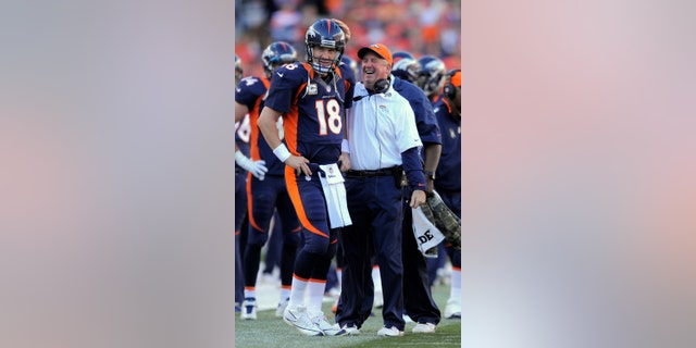 FILE - In this Nov. 17, 2012, file photo, Denver Broncos quarterback Peyton Manning (18) looks on as head coach John Fox celebrates during an NFL football game between the Denver Broncos and the San Diego Chargers in Denver. The Broncos have reeled off nine consecutive wins after a 2-3 start. (AP Photo/Jack Dempsey, File)