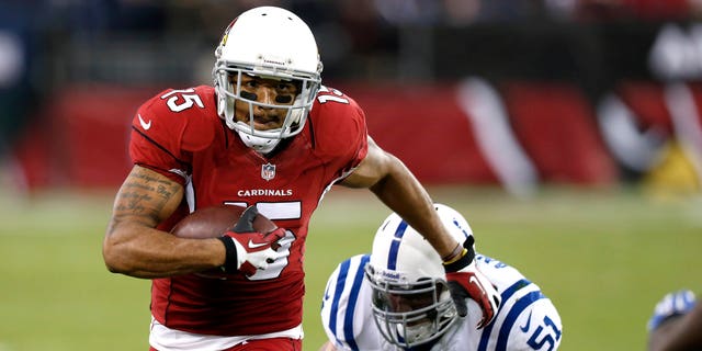 Arizona Cardinals wide receiver Michael Floyd (15) gains yards as Indianapolis Colts inside linebacker Pat Angerer (51) defends during the first half of an NFL football game, Sunday, Nov. 24, 2013, in Glendale, Ariz. (AP Photo/Ross D. Franklin)