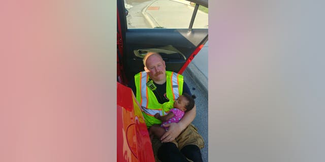 A photo of Capt. Chris Blazek, of the Chattanooga Fire Department, cradling a baby after she was in a car accident on State Route 58 has gone viral since the department posted it to Facebook Monday.
