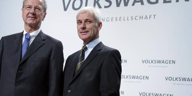 Hans Dieter Poetsch, chairman of the board of directors of Volkswagen, left, and Matthias Mueller, CEO of Volkswagen, right, pose for the media prior to a press conference of the German car manufacturer Volkswagen in Wolfsburg, Germany, Thursday, Dec. 10, 2015. (AP Photo/Michael Sohn)