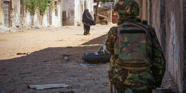 A Kenyan soldier serving with the African Union Mission in Somalia keeps watch on a street in the southern Somali port city of Kismayo on October 5, 2012, in a photo released by the African Union-United Nations Information Support Team