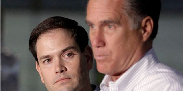 2012: Sen. Marco Rubio, R-Fla. listens at left as GOP presidential candidate Mitt Romney speaks in Aston, Pa.