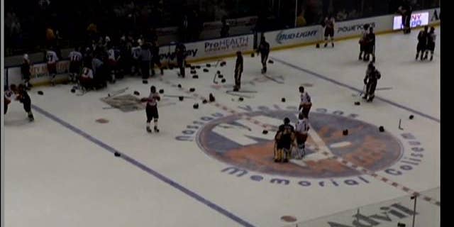 April 6, 2014: Officials try to break up a brawl between hockey teams representing the NYPD and the FDNY at Nassau Coliseum in Uniondale, Long Island (MyFoxNY.com)