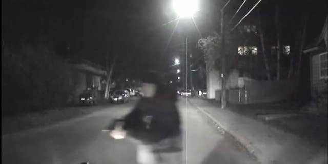 An image from video provided by the Fairbanks Police Department shows shows the suspect police believe abandoned a police car he stole after he shot an officer in Fairbanks, Ak., early Sunday, Oct. 16, 2016. An Alaska police officer was seriously injured in the early morning shooting, according to the Fairbanks police department. The Fairbanks News-Miner reports the officer was flown to Anchorage for treatment. Police are still searching for the shooter. (Fairbanks Police Department via AP)