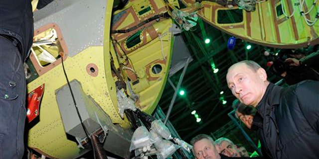 Feb. 20, 2012: Russian Prime Minister and presidential candidate Vladimir Putin, right, listens to an explanation during a visit to Komsomolsk-on-Amur Aircraft Building Corporation in Komsomolsk-on-Amur about 3,900 miles east of Moscow.