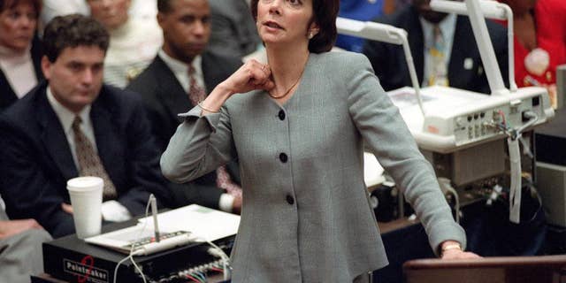 In this Sept. 29, 1995 photo, prosecutor Marcia Clark makes her closing arguments during the O.J. Simpson double-murder trial in Los Angeles, demonstrating on her own neck where a knife wound was sustained by murder victim Ronald Goldman in 1994.