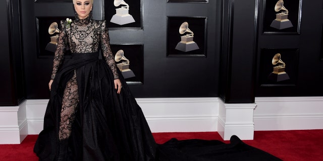 Lady Gaga turned heads in a black, satin ball gown with a sheer and embellished, high neck top. The skirt of the dress was also featured embellished, sheer pants underneath.