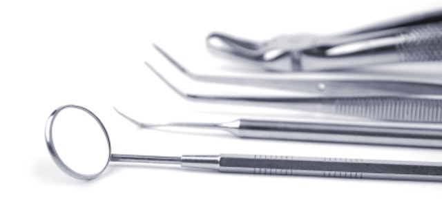 Dental tools on a white background. Selective focus.