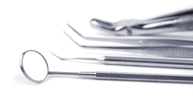 Dental tools on a white background. Selective focus.