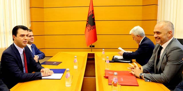 Delegations headed by Prime Minister Edi Rama, right, of the governing left-wing Socialist Party and Lulzim Basha, left, of the center-right Democratic Party meet at the Palace of Congresses to discuss on a judicial reform considered as a decisive step for the country's further moves toward membership of the European Union. (AP Photo/Hektor Pustina)