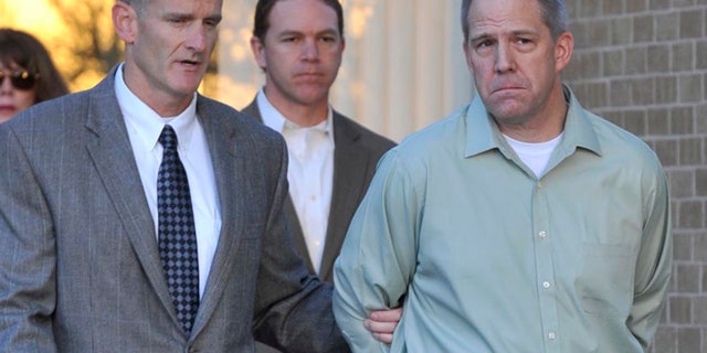 April 2, 2012: In this file photo JetBlue pilot Clayton Frederick Osbon, right, is escorted to a waiting vehicle by FBI agents as he is released from The Pavilion at Northwest Texas Hospital, in Amarillo, Texas.