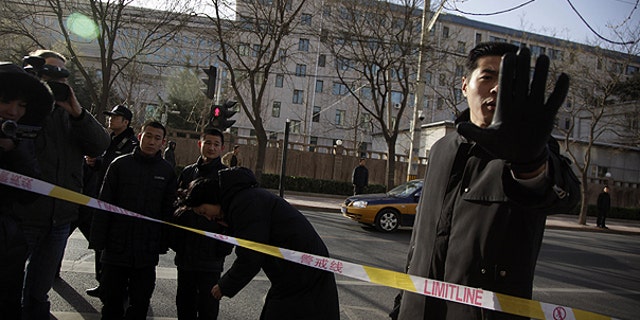 Dec. 10: A plain clothes security person blocks a photographer in an area cordoned off for journalists to work outside the residential compound where Liu Xia, the wife of Nobel Peace Prize winner Liu Xiaobo lives in Beijing, China.