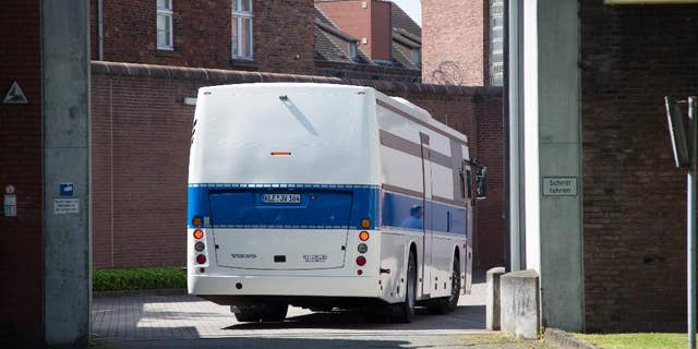 A bus for prisoners drives into the prison in Muenster, western Germany, Thursday, July 7, 2016. More than 500 inmates are being evacuated from the prison after experts said parts of the building were so dilapidated they could collapse any time. (Friso Gentsch/dpa via AP)