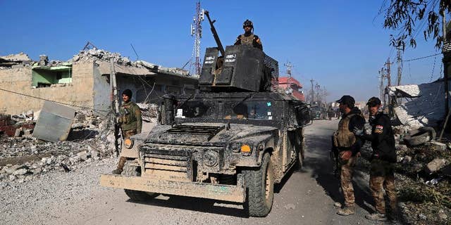 Iraq's elite counterterrorism forces inspect defenses after regaining control of the Quds neighborhood of Mosul, Iraq, Monday, Jan. 2, 2017. (AP Photo/ Khalid Mohammed)