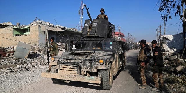 Iraq's elite counterterrorism forces inspect defenses after regaining control of the Quds neighborhood of Mosul, Iraq, Monday, Jan. 2, 2017. 