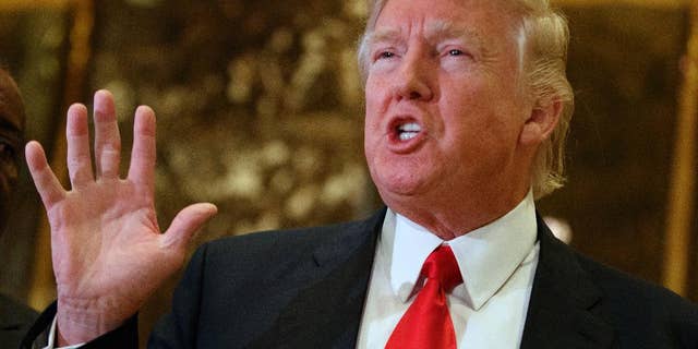 FILE - In this Jan. 13, 2017 file photo, President-elect Donald Trump speaks with reporters in the lobby of Trump Tower in New York. Trump has offered views on U.S. relations with Asia that could indicate radical shifts in long-standing policy toward the region. From opposing free trade agreements to confronting China and questioning Japan-South Korea alliances, he appears set to be charting a course far different from previous administrations. (AP Photo/Evan Vucci, File)