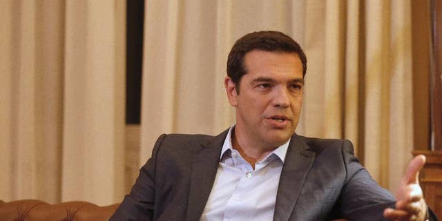 Greek Prime Minister Alexis Tsipras, meets with Greek President Prokopis Pavlopoulos, in Athens, Thursday, Aug. 20, 2015. Tsipras announced his government’s resignation and called early elections Thursday, seeking to consolidate his mandate to implement a new three-year international bailout that sparked a rebellion within his radical left Syriza party. (AP Photo/Petros Giannakouris)