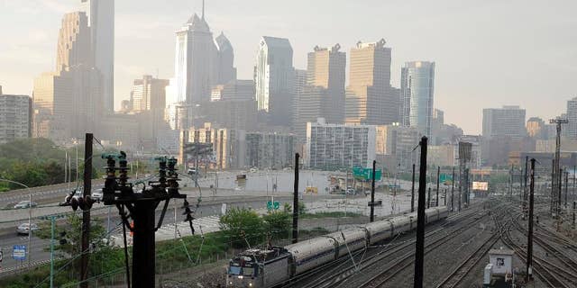 An Amtrak train travels northbound from 30th Street Station, Monday, May 18, 2015 in Philadelphia. Amtrak's Northeast Corridor trains resumed service Monday following last week's deadly derailment that killed eight people and injured more than 200 others. (AP Photo/Matt Slocum)