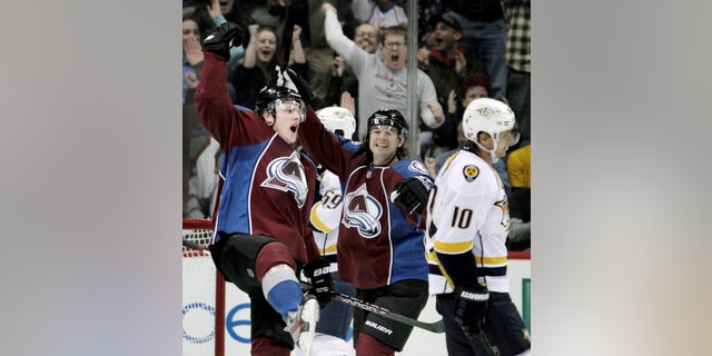 Colorado Avalanche left wing Jamie McGinn (11) celebrates his goal with Avalanche right wing P.A. Parenteau (15) during the second period of an NHL hockey game against the Nashville Predators, Monday, Feb. 18, 2013, in Denver. Predators left wing Martin Erat (10), of the Czech Republic, skates away. (AP Photo/Joe Mahoney)