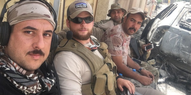 Ephraim Mattos waiting for a ride to the front lines with a few Iraqi soldiers. (May 2017)