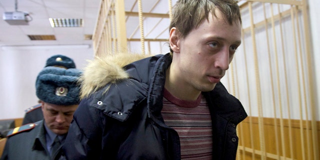 March 7, 2013: Pavel Dmitrichenko, foreground, is escorted out of a courtroom in Moscow, Russia. The star dancer accused of masterminding the attack on the Bolshoi ballet chief acknowledged Thursday that he gave the go-ahead for the attack, but told a Moscow court that he did not order anyone to throw acid on the artistic director's face.