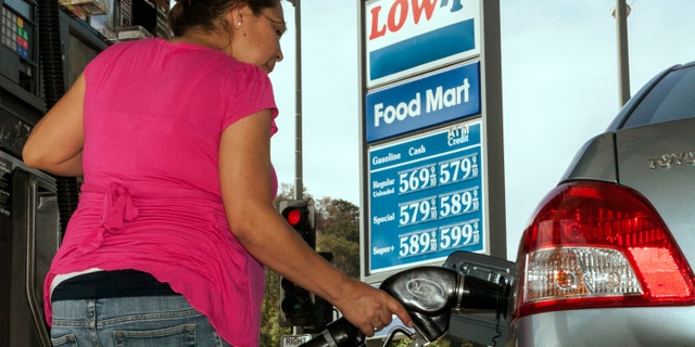 Oct. 5, 2012: Motorist Elisabeth Chavarria fills up only six dollars worth of gas to be able to drive home Friday, Oct. 5, 2012, at the Low-P, an independent gas station in Calabasas, Calif.