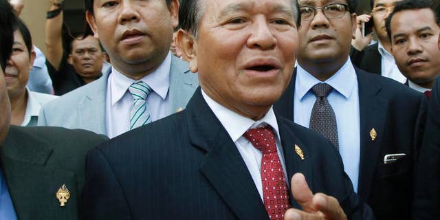 In this April 8, 2015 photo, Cambodia's main opposition Cambodia National Rescue Party Deputy President and National Assembly Deputy President Kem Sokha, center, speaks to the media outside the Phnom Penh Municipality Court in Phnom Penh, Cambodia. The senior leader of Cambodia’s opposition party was stripped of his post as the vice-president of parliament in a skewed and unexpected vote Friday, Oct. 30, 2015 that was attended only by the ruling party. (AP Photo/Heng Sinith)