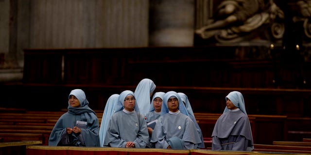 Nuns wait for the arrival of Pope Francis for a ceremony to bless a mosaic dedicated to Filipino St. Pedro Calungsod, in St. Peter's Basilica at the Vatican, Thursday, Nov. 21, 2013. (AP Photo/Andrew Medichini)