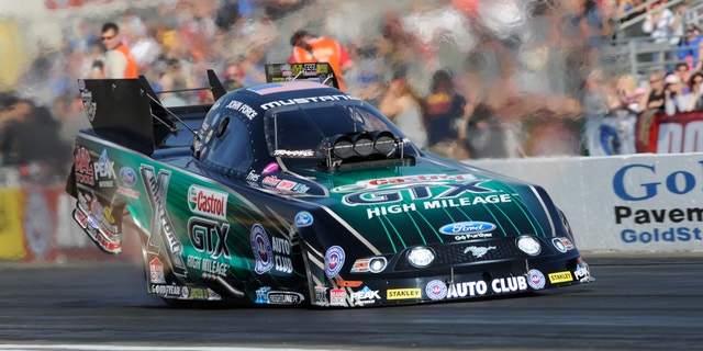 In this photo provided by the NHRA, John Force races during qualifying position in Funny Car at the NHRA Winternationals drag races at Auto Club Raceway on Saturday, Feb. 8, 2014, in Pomona, Calif. His time from Friday night stood up for the rest of qualifications. (AP Photo/NHRA, Jerry Foss)