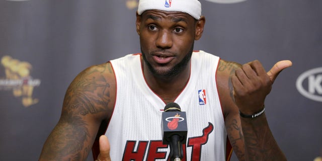 Miami Heat forward LeBron James gestures as he answers questions at a news conference during NBA basketball media day, Monday, Sept. 30, 2013 in Miami. (AP Photo/Wilfredo Lee)