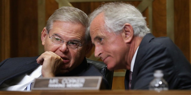 Sen. Robert Menendez, D-N.J., right, and Sen. Bob Corker, R-Tenn. talk on Capitol Hill in Washington. (Photo by Chip Somodevilla/Getty Images)