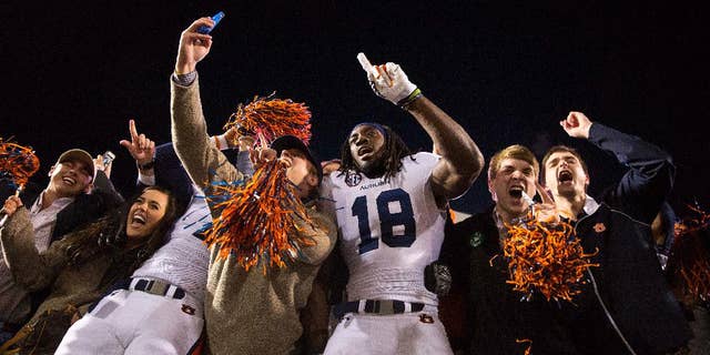 Auburn wide receiver Sammie Coates (18) celebrates with Auburn fans after a victory over Mississippi in an NCAA college football game, Saturday, Nov. 1, 2014, in Oxford, Miss. Auburn won 35-31. (AP Photo/Brynn Anderson)