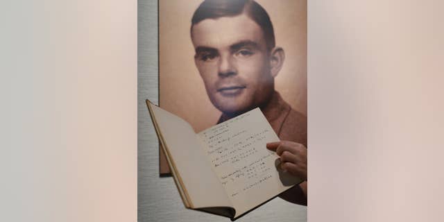 FILE - In this March 19, 2015 file photo, a page from the notebook of Alan Turing, the World War II code-breaking genius, is displayed in front of his portrait at an auction preview in Hong Kong. Turing, who was convicted of indecency in 1952 for being gay and later killed himself, was awarded a posthumous royal pardon in 2013. Britain's government announced Thursday, Oct. 20, 2016, that it will posthumously pardon thousands of gay and bisexual men convicted under the long-repealed anti-gay laws. (AP Photo/Kin Cheung, File)