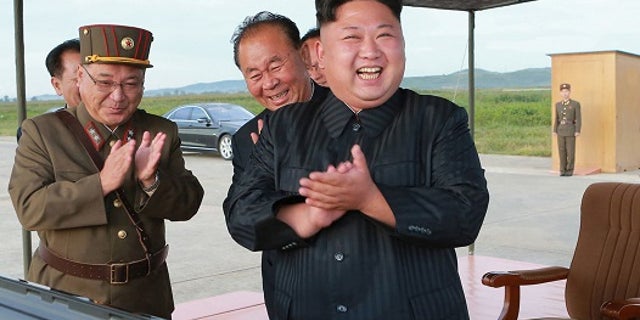 In this undated file photo distributed on Sept. 16, 2017, by the North Korean government, North Korean leader Kim Jong Un, right, celebrates what was said to be the test launch of an intermediate range Hwasong-12 missile at an undisclosed location in North Korea.