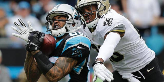 FILE - In this Dec. 22, 2013, file photo, Carolina Panthers' Steve Smith, left, catches a pass as New Orleans Saints' Keenan Lewis, right, defends in the first half of an NFL football game in Charlotte, N.C. The Panthers released their all-time leading receiver on Thursday, March 13, 2014, after 13 seasons. (AP Photo/Chuck Burton, File)