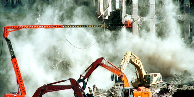 396041 01: Weeks after the World Trade Center attacks, firefighters keep clearing the rubble October 17, 2001 in New York. A section of the facade from the south tower of the World Trade Center was brought down with a cloud of dust Tuesday as cleanup of the disaster site entered its sixth week. (Photo by Shaul Schwarz/Getty Images)