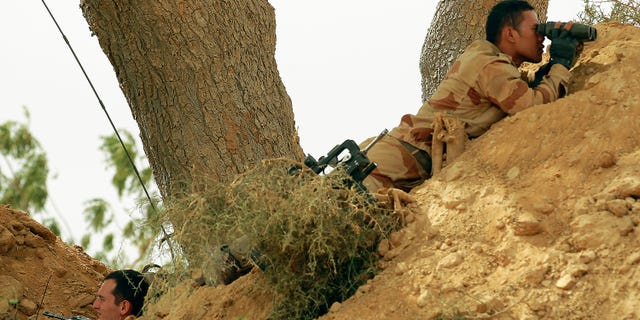 Jan. 22, 2013: French foreign legionnaires take position outside Marakala, central Mali, some 240kms from Bamako. French troops in armored personnel carriers rolled through the streets of Diabaly on Monday, winning praise from residents of this besieged town after Malian forces retook control of it with French help a week after radical Islamists invaded.