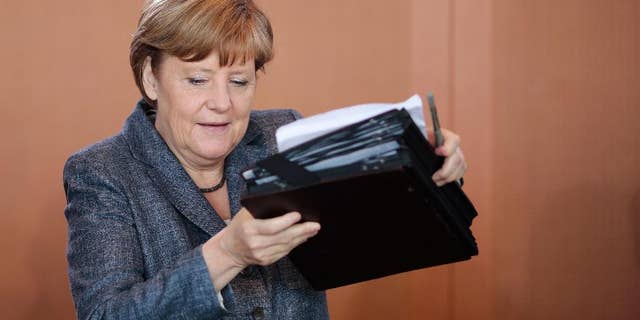 German Chancellor Angela Merkel arrives for the beginning of German government's weekly cabinet meeting at the chancellery in Berlin, Germany, Wednesday, June 3, 2015. (AP Photo/Markus Schreiber)