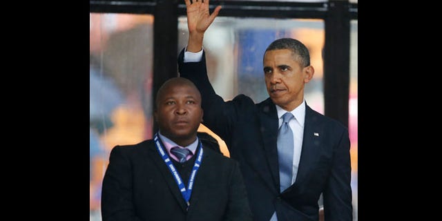 Dec. 10, 2013: President Barack Obama waves standing next to the sign language interpreter after making his speech at the memorial service for former South African president Nelson Mandela at the FNB Stadium in Soweto near Johannesburg. South Africa's deaf federation said on Wednesday that the interpreter on stage for Mandela memorial was a 'fake.'