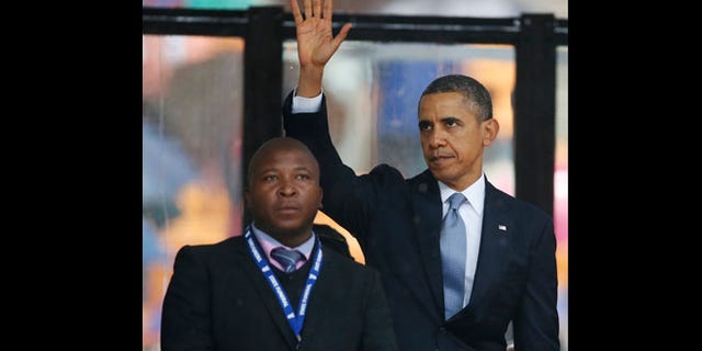 Dec. 10, 2013: President Barack Obama waves standing next to the sign language interpreter after making his speech at the memorial service for former South African president Nelson Mandela at the FNB Stadium in Soweto near Johannesburg. South Africa's deaf federation said on Wednesday that the interpreter on stage for Mandela memorial was a 'fake.'