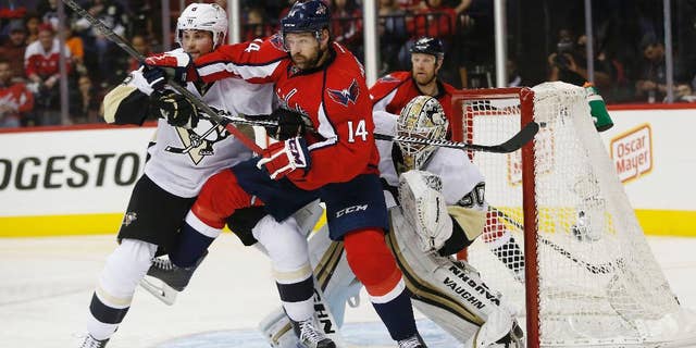 Washington Capitals right wing Justin Williams (14) and Pittsburgh Penguins defenseman Brian Dumoulin (8) shove each other as they work in front of Pittsburgh Penguins goalie Matt Murray (30) during the second period of Game 5 in an NHL hockey Stanley Cup Eastern Conference semifinals Saturday, May 7, 2016, in Washington. (AP Photo/Pablo Martinez Monsivais)